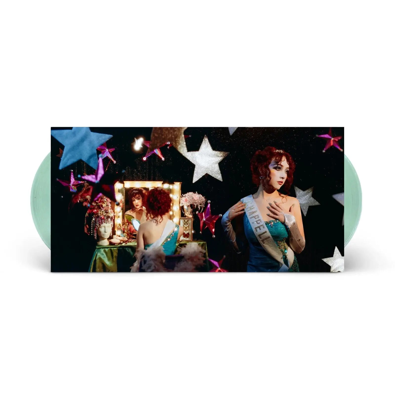 A Chappell Roan vinyl album features the artist in a dressing room with a mirror.
