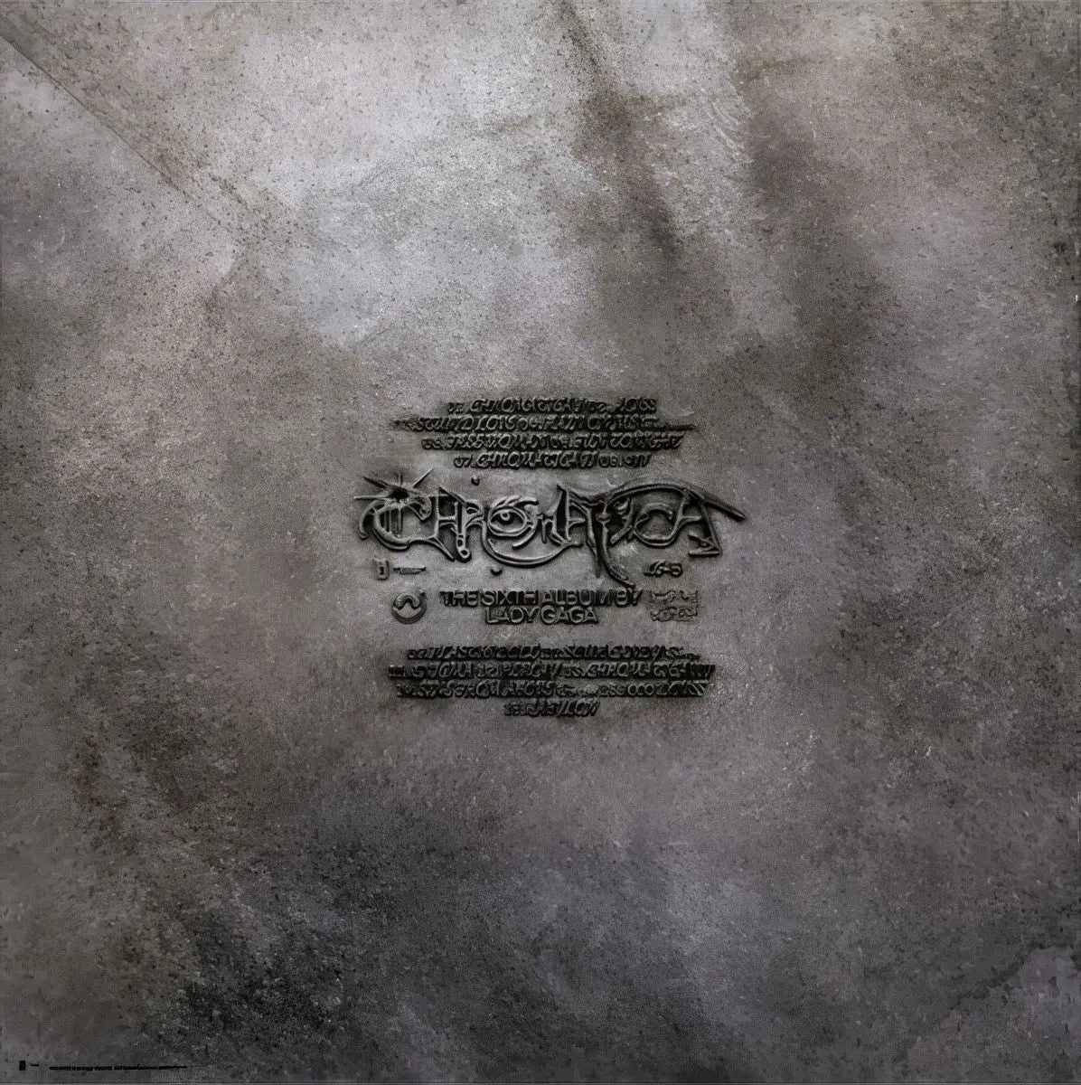 Lady Gaga's Chromatica album cover features a metallic, textured background with embossed text.