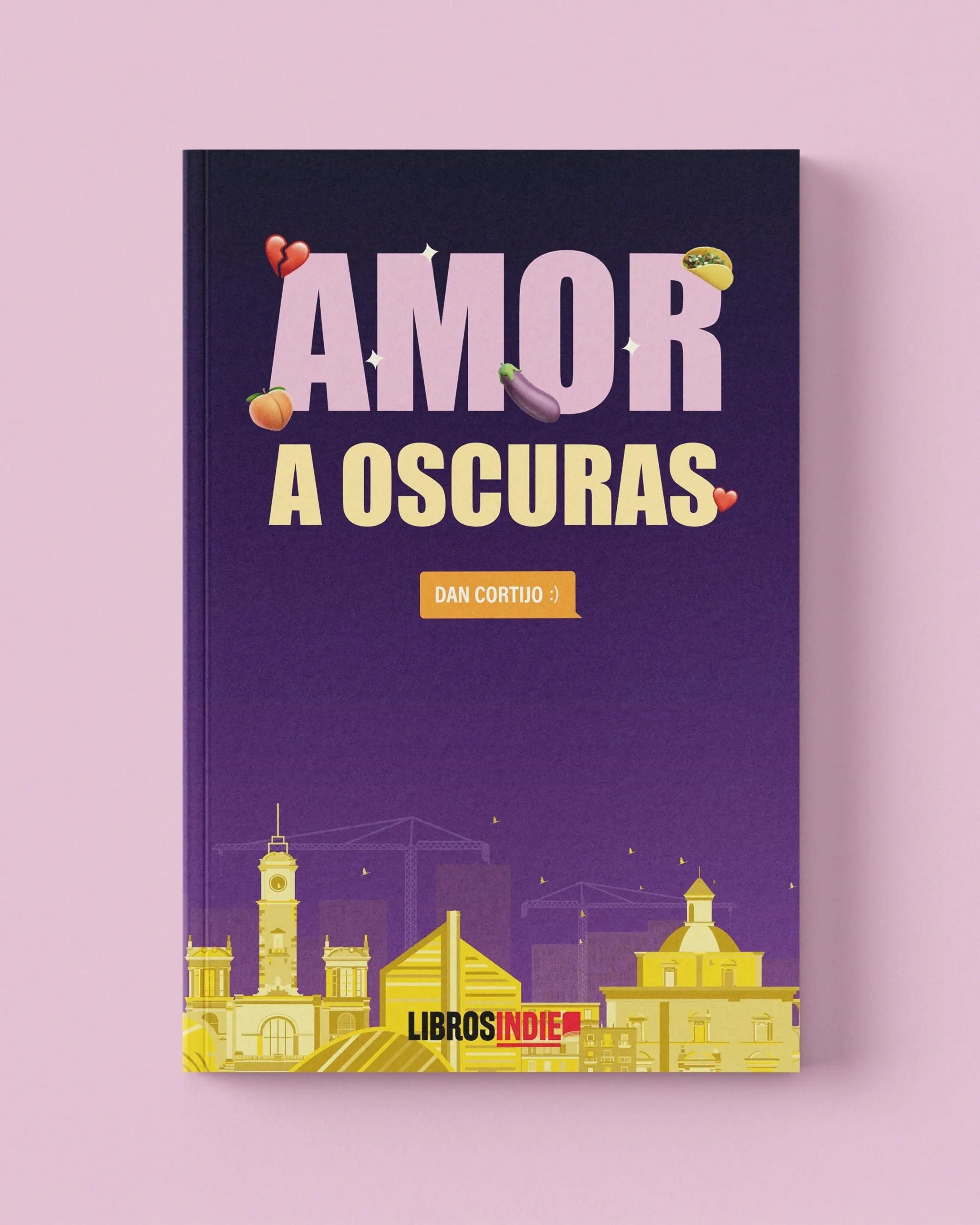Un libro morado con el título "AMOR A OSCURAS" y edificios amarillos en la parte inferior.